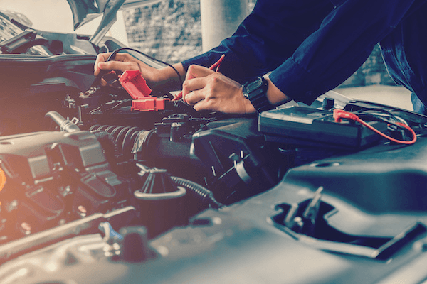 Technician repairing a vehicle wiring harness